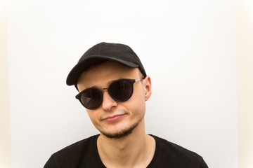 emotion serious, young man in black cap and black glasses on a white background, people emoji