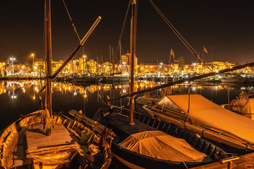 Boats in Alghero harbor at night