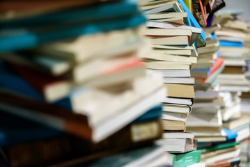 Pile of new and old books framed.