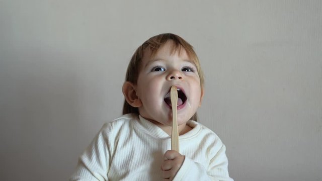 Child girl brushes her teeth with a bamboo toothbrush. zero waste concept