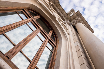 Large historic building with large columns, seen at a low angle, with a sky in the background, called Correos in Valencia, Spain.