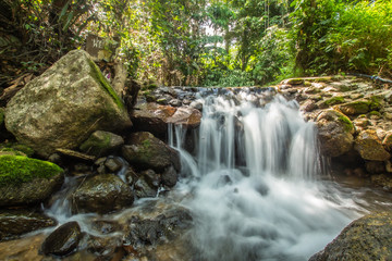 Fototapeta premium Kathu Waterfall in the tropical forest area In Asia, suitable for walks, nature walks and hiking, adventure photography Of the national park Phuket Thailand,Suitable for travel and leisure.