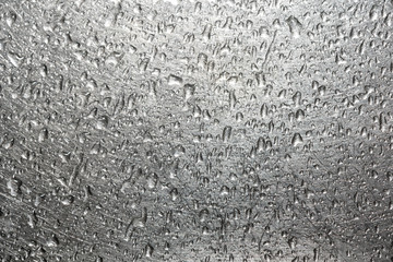 Drops of water on a scratched metal background closeup