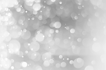 Obraz na płótnie Canvas Silver and white bokeh lights defocused. Blurred background.