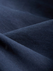 Textile - Fibers close-up showing paterns of the fabric. Soft background and ondulations creating shadows and volumes