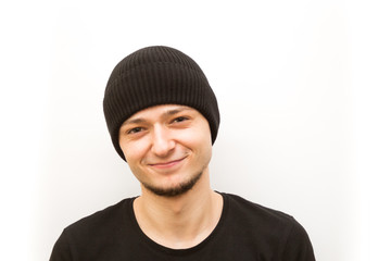 emotion smile, young man in a black cap on a white background, man emoji