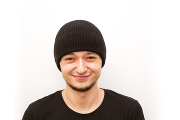 emotion grining, young man in a black cap on a white background, man emoji