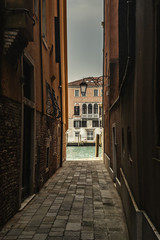 Narrow alley by Venice's Grand Canal
