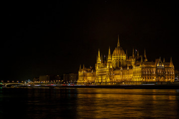 Obraz premium View on the The Hungarian Parliament Building, beside the Danube River. European travel. Night scene. Budapest. Hungarian landmarks.