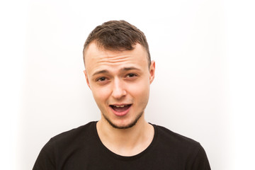 Obraz premium emotion hushed, young man in a black cap on a white background, man emoji