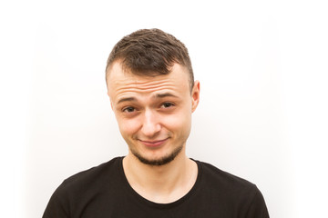 Obraz premium emotion smirk, young man in a black cap on a white background, man emoji