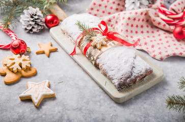 Stollen a traditional European cake with nuts and candied fruit, is dusted with icing sugar and cut into pieces