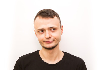 Fototapeta premium emotion smirk, young man in a black cap on a white background, man emoji