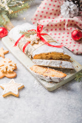 Stollen a traditional European cake with nuts and candied fruit, is dusted with icing sugar and cut into pieces