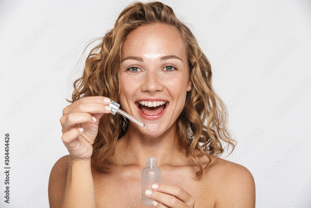 Sticker Image of happy half-naked woman smiling and using facial serum