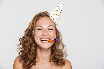 Image of happy half-naked woman with party cone and whistle laughing