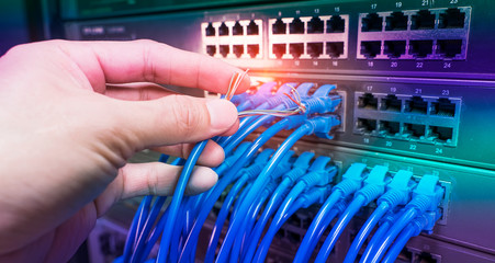 hand with damaged stranded network cable. Problem with communication