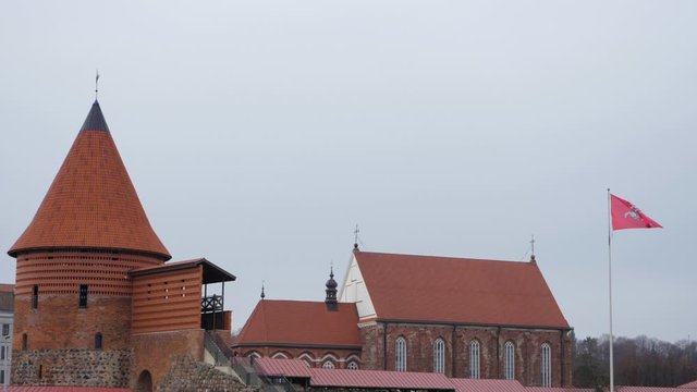 Static view of Kaunas castle with the Vytis coat of arms on a flagpost next to it
