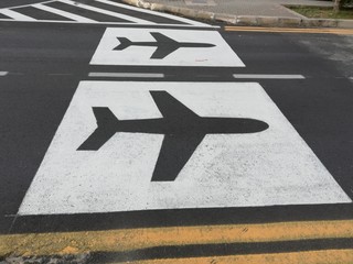 Symbol of the airplane on the asphalt