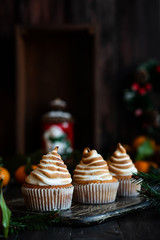 Citrus cupcakes with lemon curls and a cap from Swiss meringue