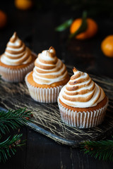 Citrus cupcakes with lemon curls and a cap from Swiss meringue