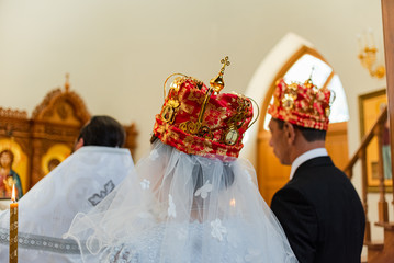 Bride and groom during a Christian wedding ceremony. Traditional headdresses. Slavic wedding.
