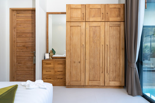 spacious and modern bedroom with wooden wardrobe