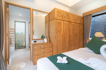 spacious and modern bedroom with wooden wardrobe
