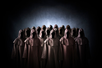 Group of scary figures in hooded cloaks