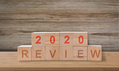 Wooden blocks with the word review 2020. Popular and relevant topics of strategy, solution, goal, business, New Year.