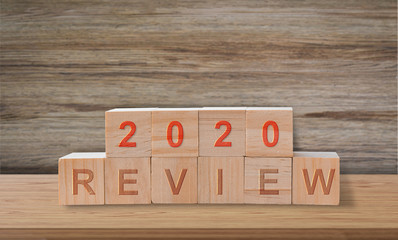 Wooden blocks with the word review 2020. Popular and relevant topics of strategy, solution, goal,...