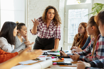 Teamwork. Young people discussing about women rights and equality at the office. Caucasian businesswomen or office workers have meeting about problem in workplace, male pressure and harassment.