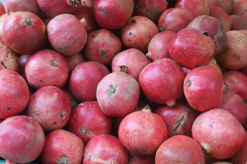 closeup of a hand taking a tomato from a market stall