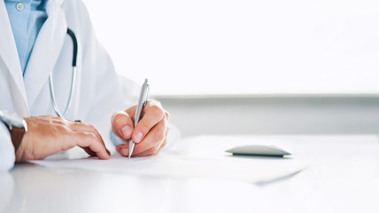 Close up of doctor signing prescription for patient - obrazy, fototapety, plakaty