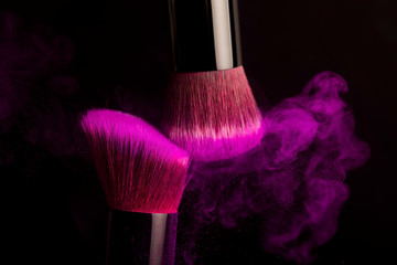 Cosmetics brush and colorful makeup powder