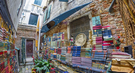 Naklejka premium VENICE - APRIL 10, 2014: Acqua Alta library with old books collection is a famous tourist attraction