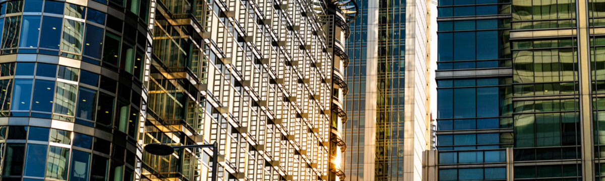 Modern City Building Architecture With Glass Fronts On A Clear Day At Sunset In London, England Panoramic