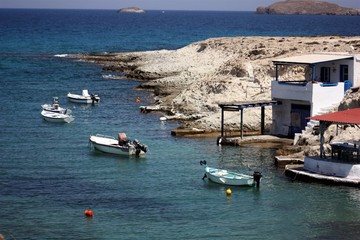 Milos island, Greece:  fishing boats and houses, with the typical Aegean architecture