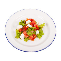Caprese salad with mozarella cheese, tomatoes and basil isolated on white.