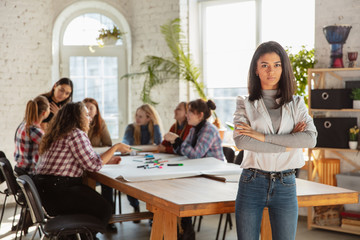 Women's rights and equality at the office. Caucasian businesswomen or young confident model crossed hands in front of coworkers having meeting about problem in workplace, male pressure and harassment.