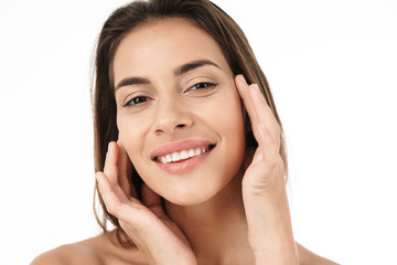 Portrait of young brunette half-naked woman smiling and touching her face