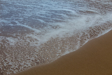 Foam on a dark sea surface