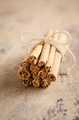 Cinnamon sticks on a brown wooden table.