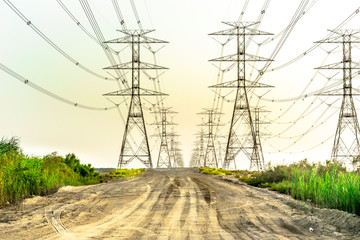 installation of a new electricity supply poles without it's cables in the middle of desert in Saudi Arabia  