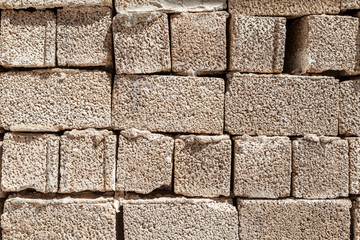 old stone wall of large bricks background