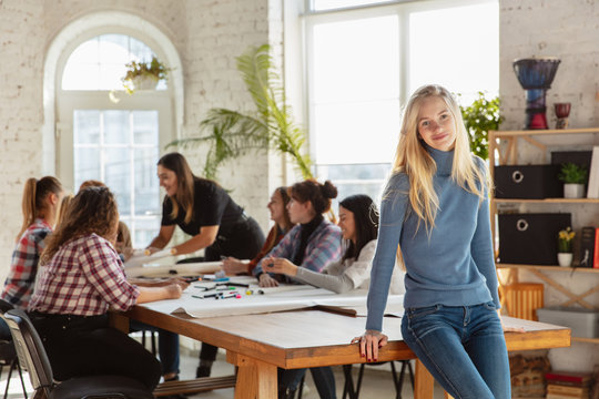 Women's rights and equality at the office. Caucasian businesswomen or young confident model smiling in front of coworkers having meeting about problem in workplace, male pressure and harassment.