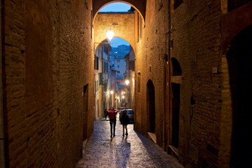 people walking in Siena by night