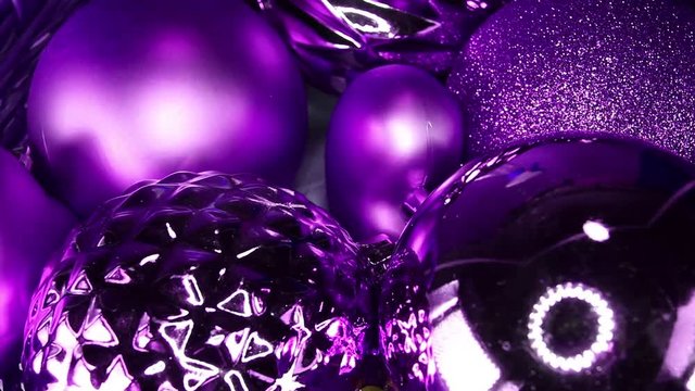 Purple Christmas ball glass ball bauble baubles on slow motion rotating plate Xmas ornaments