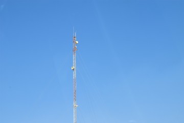 a very tall mobile tower and blue sky in the background 
