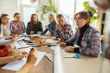 Young women preparing poster about women's rights and equality at the office. Caucasian businesswomen or office workers have meeting about problem in workplace, male pressure and harassment.